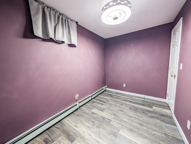 14 Hampton Rd, Sound Beach, NY 11789 - spare room with a baseboard heating unit and wood finished floors