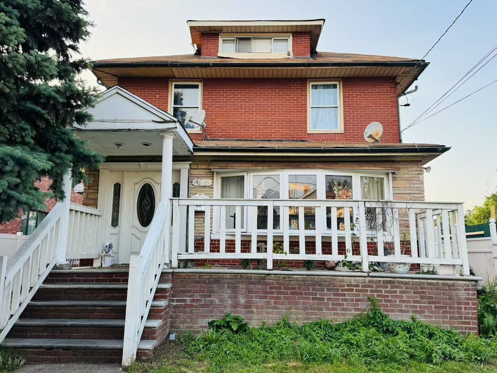 146-29 33rd Ave, Flushing, NY 11354 - view of front of home featuring brick siding and covered porch