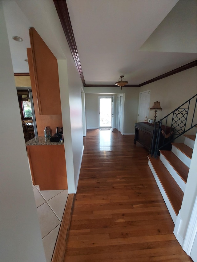 404 Club Ct, Oceanside, NY 11572 - corridor featuring crown molding, light wood-type flooring, and stairs