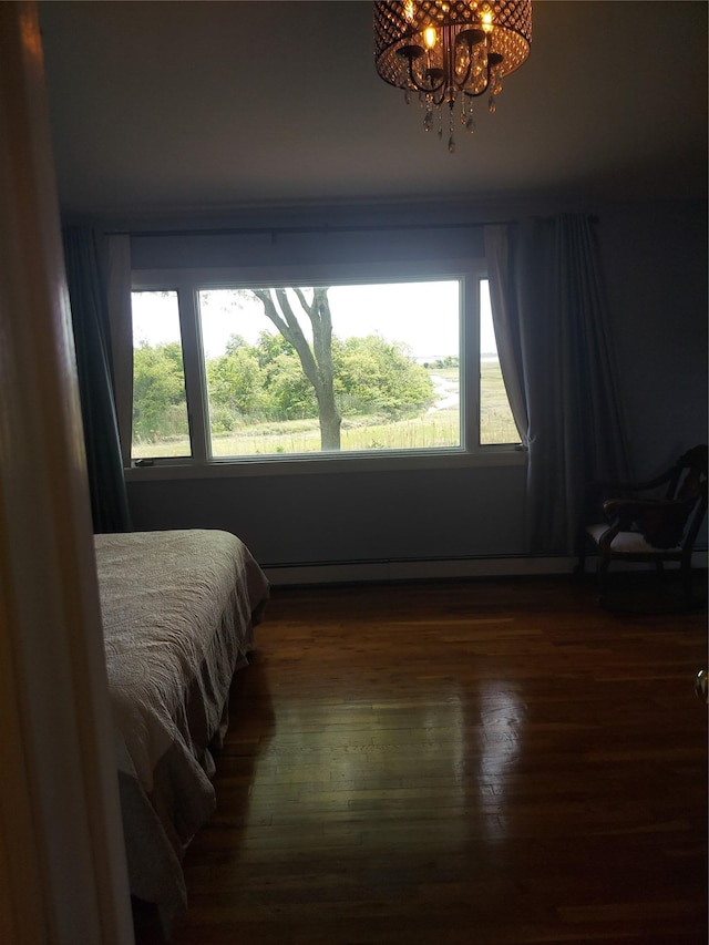 404 Club Ct, Oceanside, NY 11572 - bedroom with a chandelier, multiple windows, and dark wood finished floors