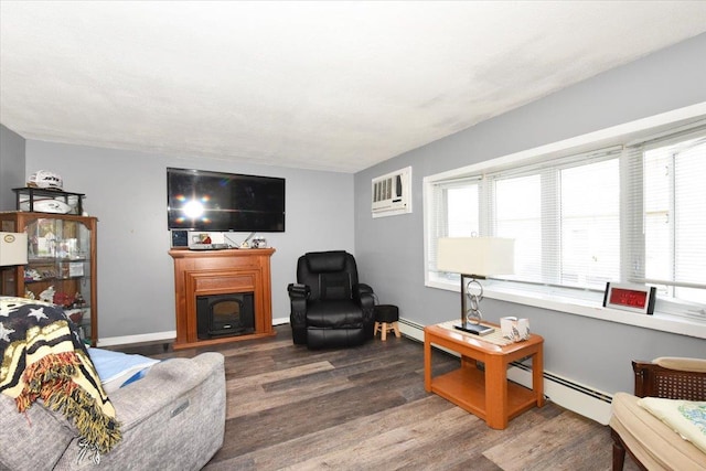 218 Mott St, Oceanside, NY 11572 - living area with wood finished floors, a fireplace, a wall mounted air conditioner, and baseboard heating