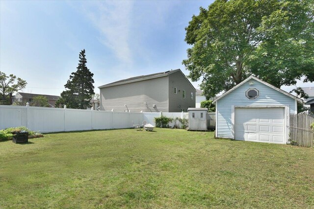 218 Mott St, Oceanside, NY 11572 - fenced backyard with a garage and a storage unit