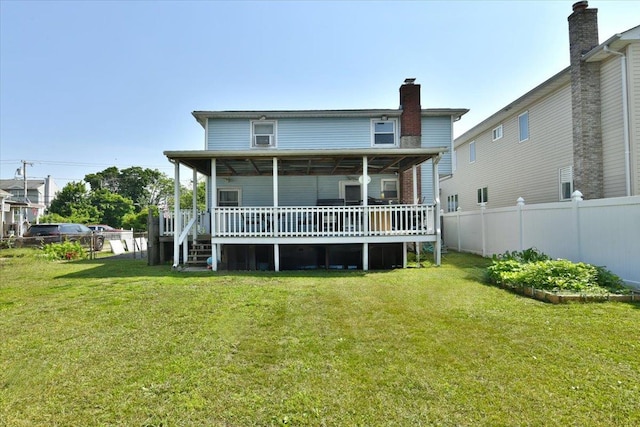 218 Mott St, Oceanside, NY 11572 - back of house featuring a chimney and a deck