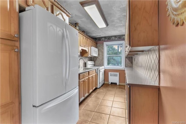 51 White Oak St Unit 2A, New Rochelle, NY 10801 - kitchen featuring white appliances, radiator, light tile patterned flooring, and light countertops