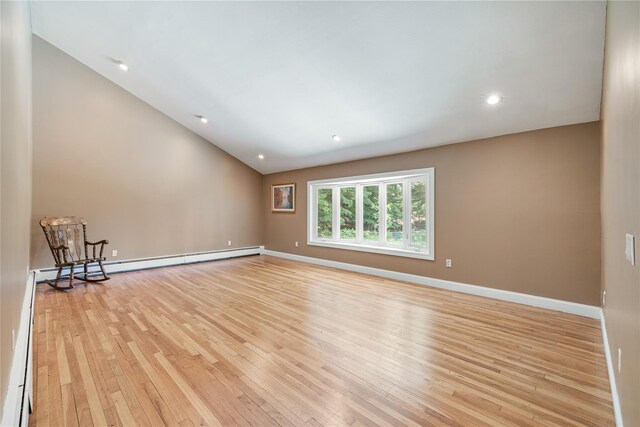 10 Salem Ct, Spring Valley, NY 10977 - empty room with light wood finished floors, lofted ceiling, and a baseboard radiator