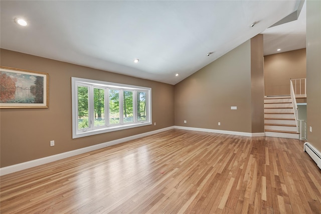 10 Salem Ct, Spring Valley, NY 10977 - spare room featuring light wood-type flooring, vaulted ceiling, stairway, and recessed lighting