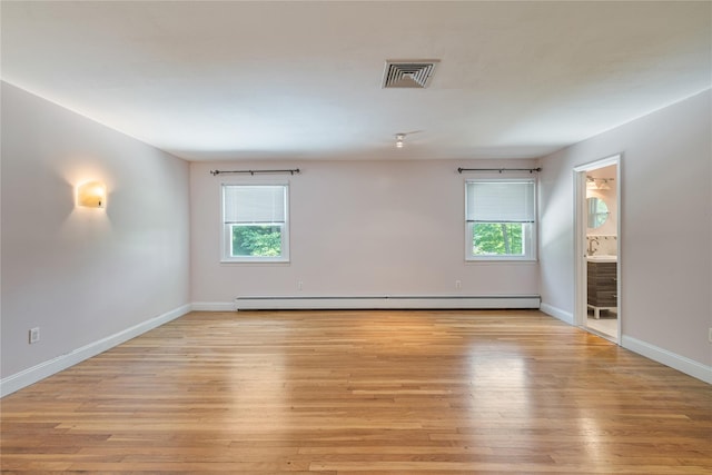 10 Salem Ct, Spring Valley, NY 10977 - empty room featuring plenty of natural light, light wood-style floors, and a baseboard radiator