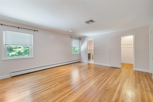 10 Salem Ct, Spring Valley, NY 10977 - unfurnished room with a baseboard radiator and light wood-style floors