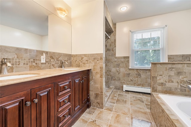 10 Salem Ct, Spring Valley, NY 10977 - full bath featuring baseboard heating, tile walls, a garden tub, tiled shower, and double vanity