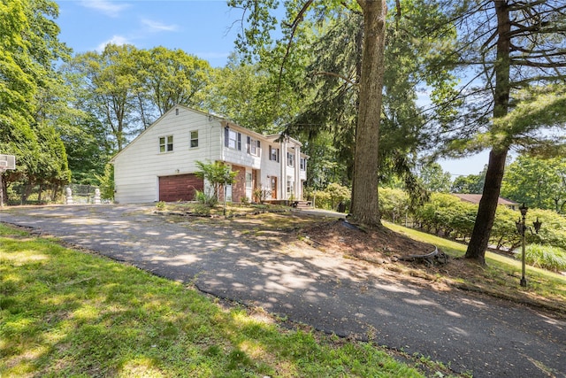 10 Salem Ct, Spring Valley, NY 10977 - view of front of property featuring asphalt driveway, an attached garage, and brick siding