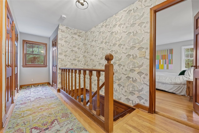 210 Foggintown Rd, Brewster, NY 10509 - hall with wallpapered walls, light wood finished floors, an upstairs landing, and an accent wall