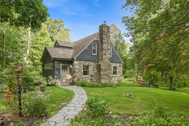 210 Foggintown Rd, Brewster, NY 10509 - view of front of home featuring stone siding, a front yard, and a chimney