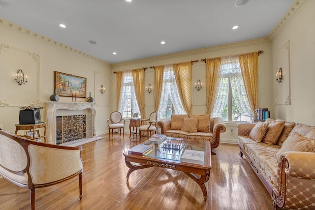 760 Hillcrest Pl, North Woodmere, NY 11581 - living area with plenty of natural light, a premium fireplace, wood finished floors, recessed lighting, and crown molding