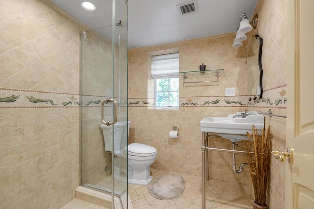 760 Hillcrest Pl, North Woodmere, NY 11581 - bathroom featuring a stall shower, tile walls, and tile patterned flooring