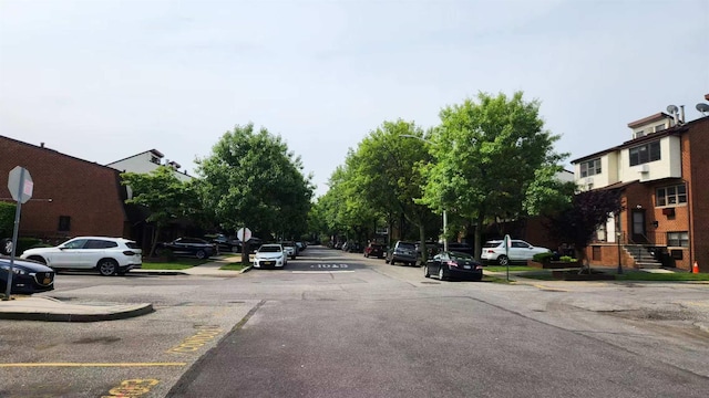 222 Capstan Ct Unit 101B, College Point, NY 11356 - view of asphalt road featuring traffic signs, sidewalks, and curbs