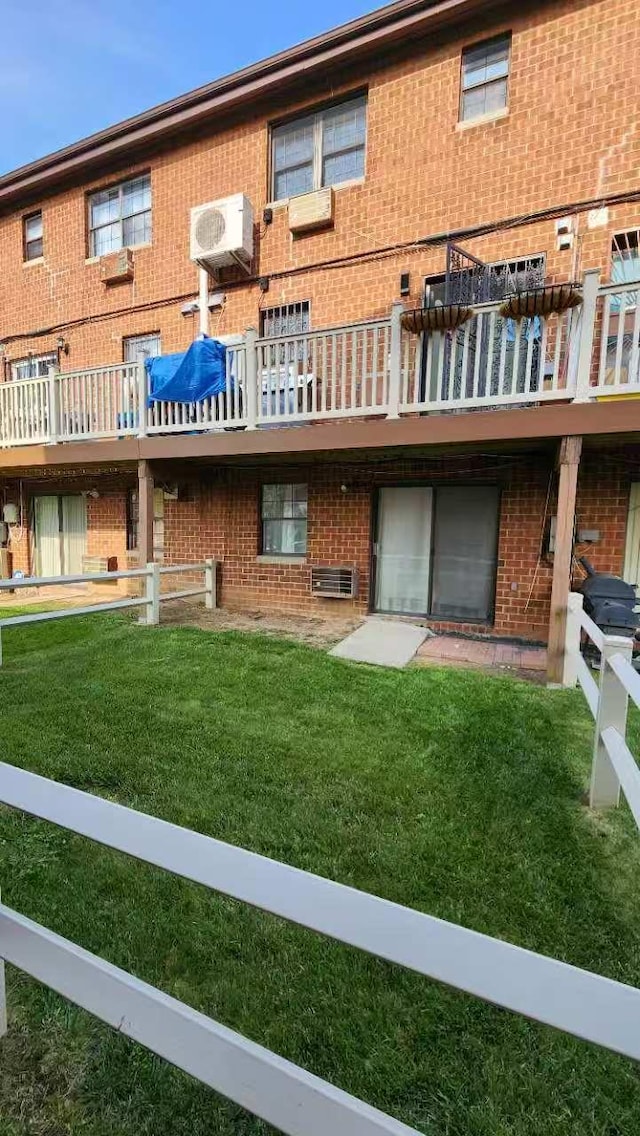 222 Capstan Ct Unit 101B, College Point, NY 11356 - rear view of house featuring brick siding and a yard