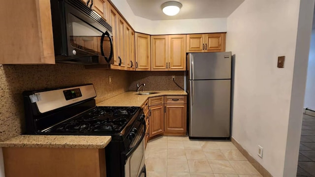 222 Capstan Ct Unit 101B, College Point, NY 11356 - kitchen featuring stainless steel appliances, backsplash, light stone countertops, and brown cabinets