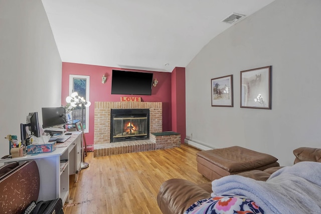 8 Peconic Ln, Selden, NY 11784 - living area with vaulted ceiling, a baseboard radiator, light wood-style flooring, and a brick fireplace