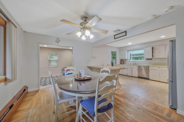 8 Peconic Ln, Selden, NY 11784 - dining room with a baseboard heating unit, ceiling fan, light wood-type flooring, and recessed lighting