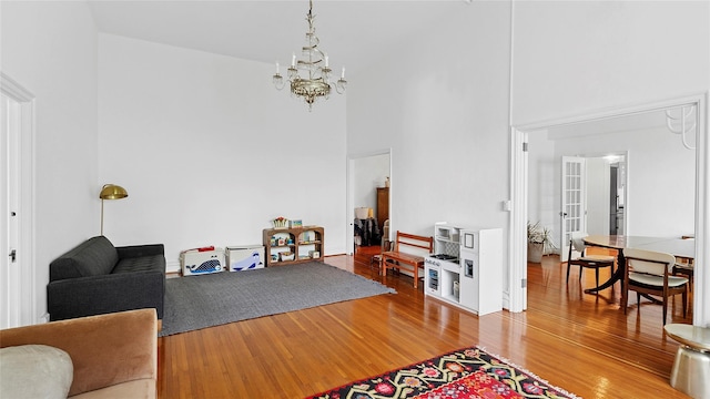 10 Holder Pl Unit 5A, Forest Hills, NY 11375 - living room featuring a high ceiling, a chandelier, and wood finished floors