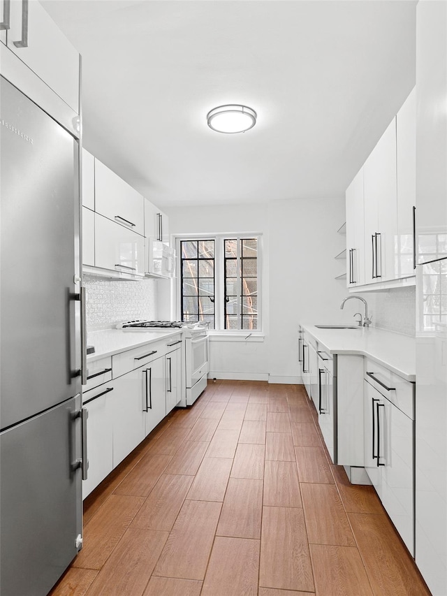 10 Holder Pl Unit 5A, Forest Hills, NY 11375 - kitchen featuring white appliances, open shelves, decorative backsplash, light countertops, and white cabinetry