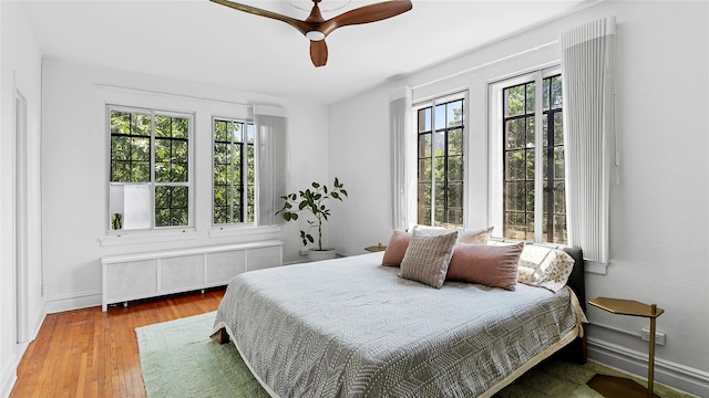 10 Holder Pl Unit 5A, Forest Hills, NY 11375 - bedroom with radiator, hardwood / wood-style floors, and ceiling fan