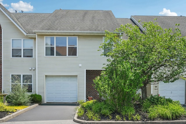 12 Deer Ct Dr, Middletown, NY 10940 - view of front of home featuring roof with shingles, brick siding, and an attached garage