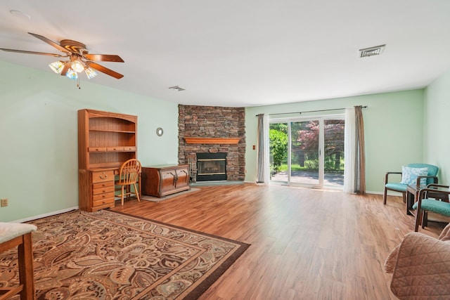 12 Deer Ct Dr, Middletown, NY 10940 - living room featuring wood finished floors, ceiling fan, and a stone fireplace