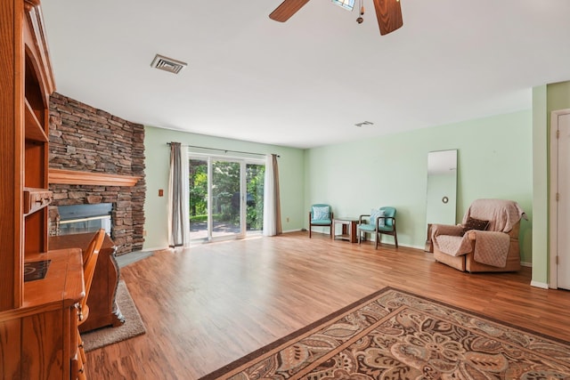 12 Deer Ct Dr, Middletown, NY 10940 - living room with a ceiling fan, wood finished floors, and a stone fireplace