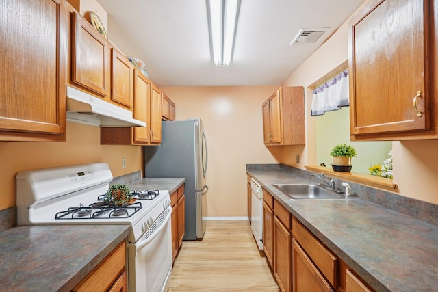 12 Deer Ct Dr, Middletown, NY 10940 - kitchen featuring white appliances, under cabinet range hood, light wood-style floors, and dark countertops