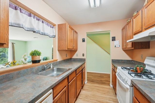 12 Deer Ct Dr, Middletown, NY 10940 - kitchen with white range with gas cooktop, light wood finished floors, dark countertops, and under cabinet range hood