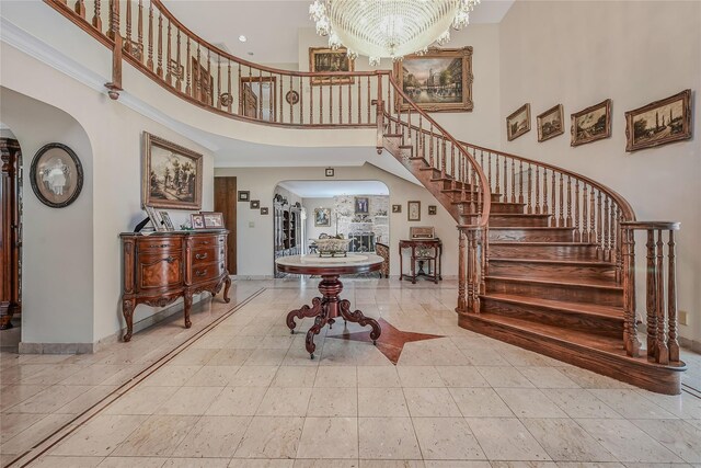 1537 Laurel Hollow Rd, Laurel Hollow, NY 11791 - entrance foyer with a high ceiling, arched walkways, stairway, a chandelier, and ornamental molding