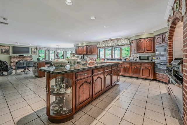 1537 Laurel Hollow Rd, Laurel Hollow, NY 11791 - kitchen featuring stainless steel microwave, dark countertops, oven, light tile patterned floors, and recessed lighting