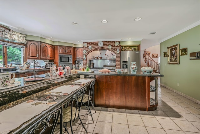 1537 Laurel Hollow Rd, Laurel Hollow, NY 11791 - kitchen featuring stainless steel fridge, built in microwave, ornamental molding, light tile patterned floors, and dark countertops