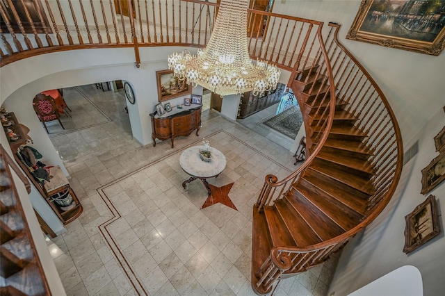 1537 Laurel Hollow Rd, Laurel Hollow, NY 11791 - staircase with a chandelier, a high ceiling, and arched walkways