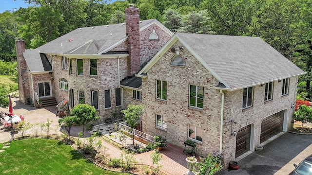 1537 Laurel Hollow Rd, Laurel Hollow, NY 11791 - view of front of property featuring a chimney, an attached garage, a patio area, and a shingled roof
