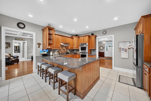 114 Bulsontown Rd, Stony Point, NY 10980 - kitchen with appliances with stainless steel finishes, under cabinet range hood, light tile patterned floors, open shelves, and a peninsula