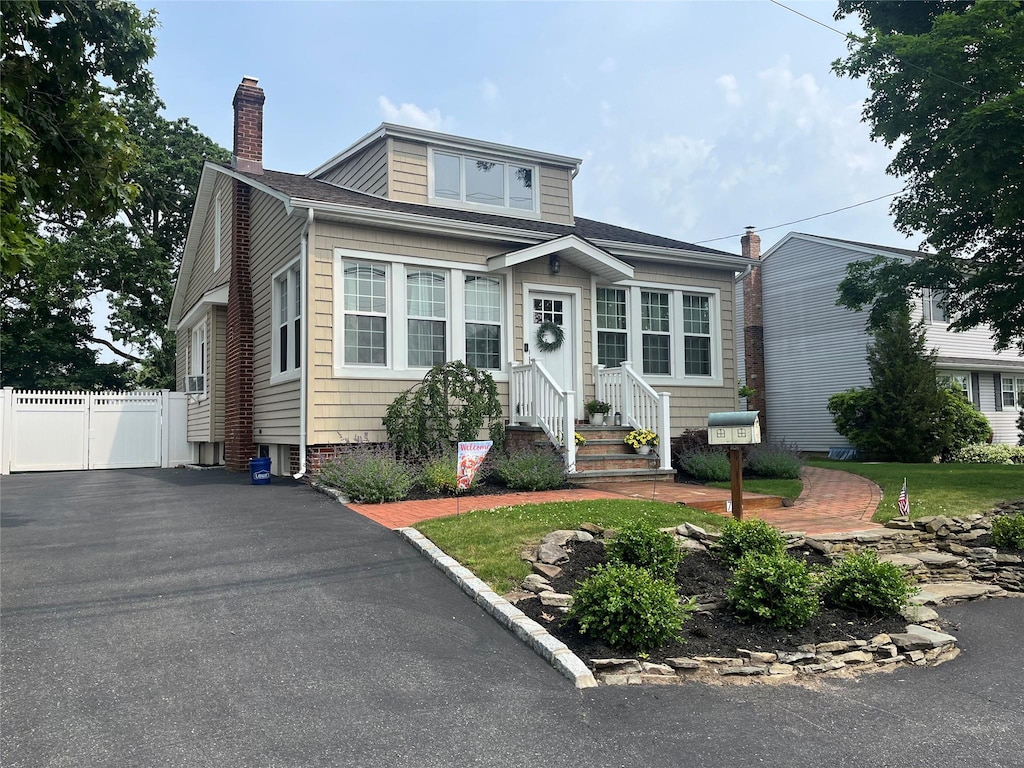 728 Hyman Ave, West Islip, NY 11795 - view of front of property featuring entry steps and a chimney