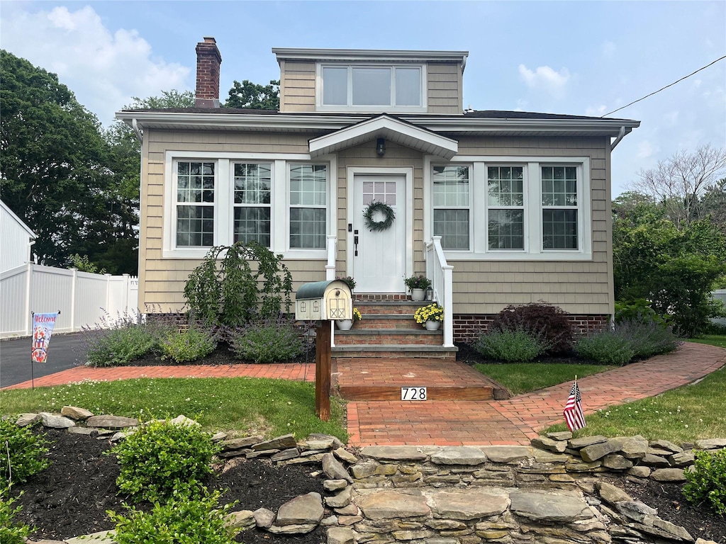 728 Hyman Ave, West Islip, NY 11795 - view of front of home with a chimney and entry steps
