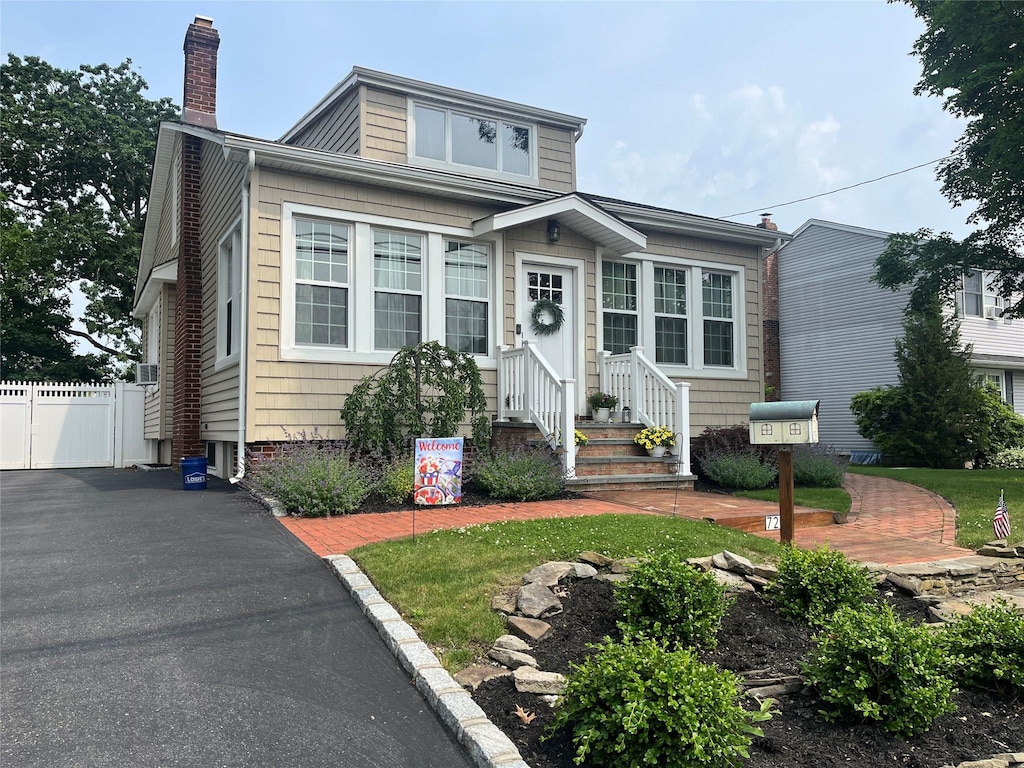 728 Hyman Ave, West Islip, NY 11795 - view of front of property with a chimney and entry steps