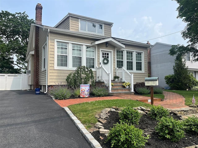 728 Hyman Ave, West Islip, NY 11795 - view of front of property with a chimney and entry steps