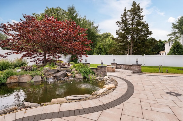 25 Segatogue Ln, South Setauket, NY 11720 - view of property's community with a garden pond and a patio area