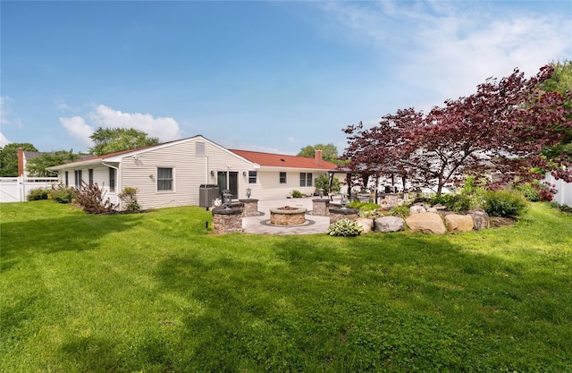25 Segatogue Ln, South Setauket, NY 11720 - rear view of house featuring an outdoor fire pit, a chimney, and a patio