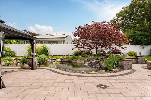 25 Segatogue Ln, South Setauket, NY 11720 - fenced backyard with a patio area, a garden pond, and a gazebo