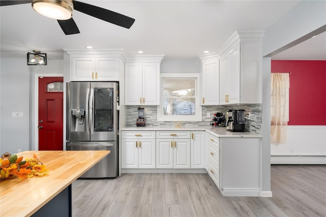 25 Segatogue Ln, South Setauket, NY 11720 - kitchen with stainless steel refrigerator with ice dispenser, a baseboard heating unit, a ceiling fan, white cabinets, and recessed lighting