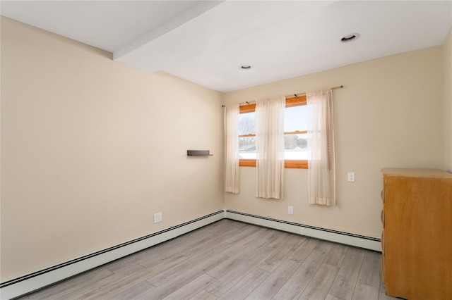 25 Segatogue Ln, South Setauket, NY 11720 - spare room featuring light wood-style floors and a baseboard radiator