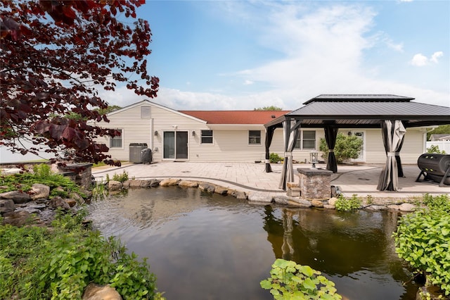 25 Segatogue Ln, South Setauket, NY 11720 - back of house with a gazebo, a patio, and a small pond