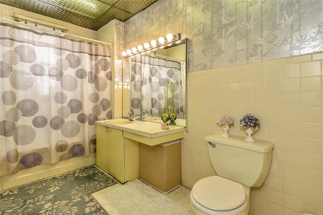 2541 83rd St, East Elmhurst, NY 11370 - full bathroom featuring wallpapered walls, vanity, tile walls, curtained shower, and wainscoting
