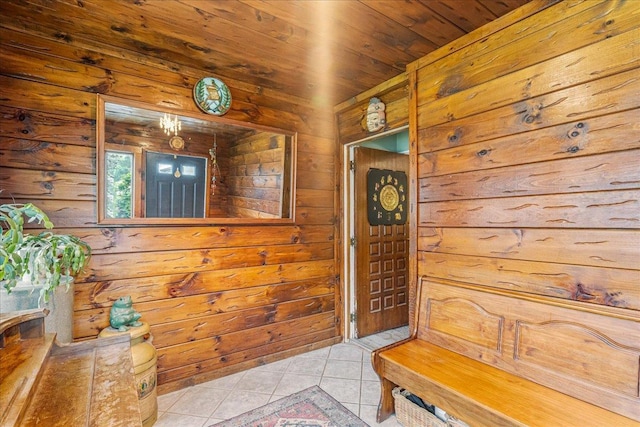 49 Radcliff Ave, Port Washington, NY 11050 - entrance foyer featuring light tile patterned flooring, wooden walls, and wooden ceiling