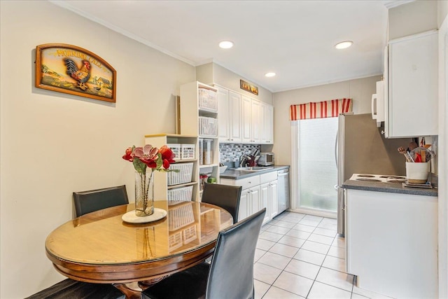 49 Radcliff Ave, Port Washington, NY 11050 - kitchen featuring white cabinetry, tasteful backsplash, light tile patterned flooring, crown molding, and dishwasher